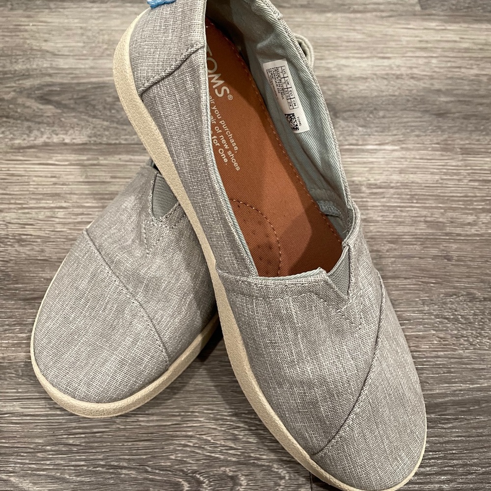 Grey slip on Toms.